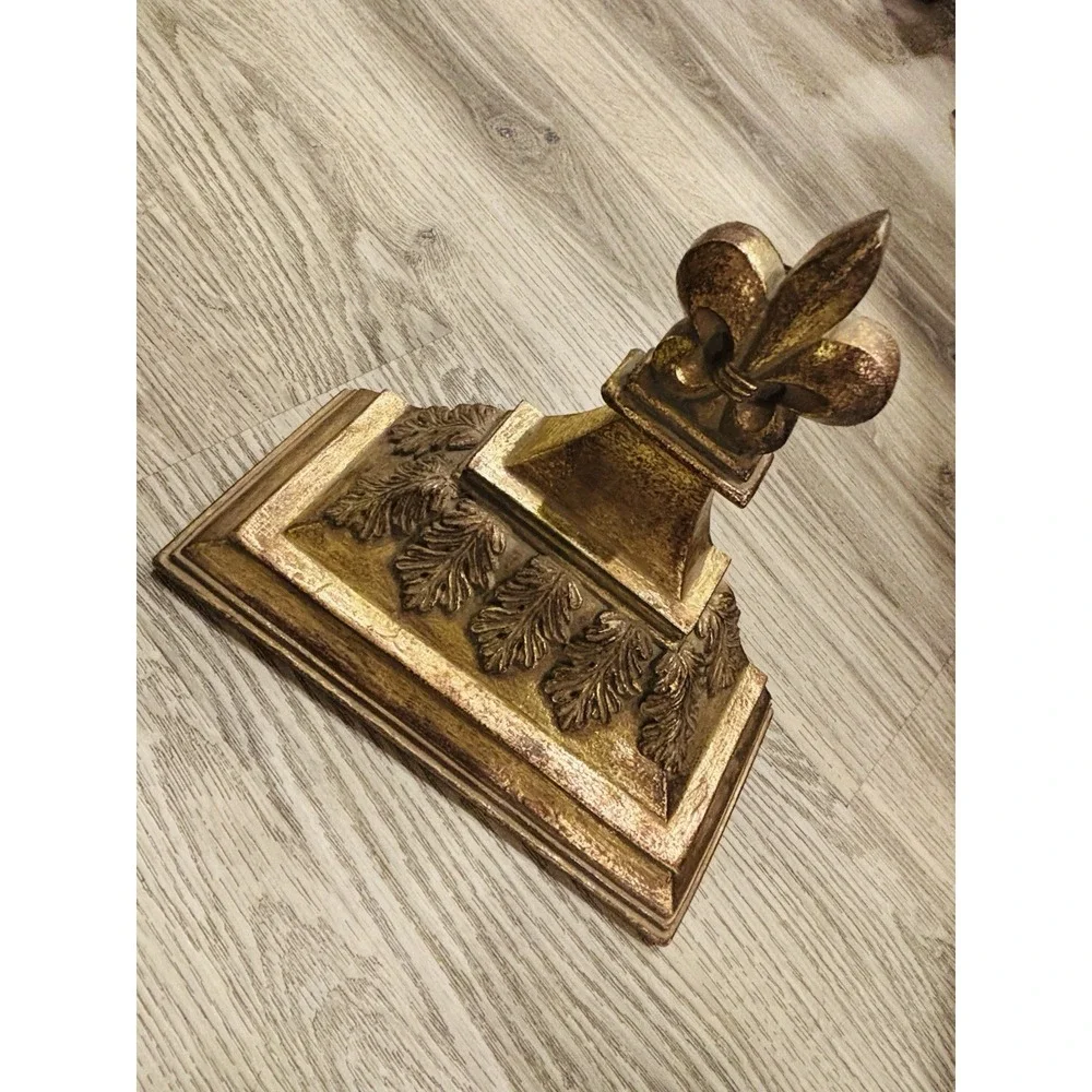 Vintage gold-toned decorative wall shelves with floral motifs.